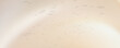 © fila - Abstract soft beige and cream gradient background with subtle splatters and bokeh light effects. vector eps10.