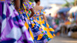 © Nataliia - Group of women in vibrant traditional dresses with colorful patterns walking together in an outdoor market setting, showcasing cultural attire and community spirit