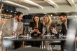© Creative Light - Business colleagues socializing, using smartphones during lunch at restaurant