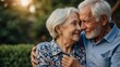 © Petro - Elderly Couple Embracing and Smiling Together in a Warm Outdoor Setting at Sunset