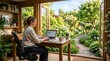 © Maria - woman working on laptop in bright cozy garden house office