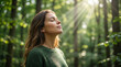 © Kamran - Woman breathing fresh morning air in peaceful forest perfect for mental health wellness relaxation and freedom concepts