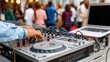 © Emilio - DJ mixing music on professional controller during outdoor party event. Modern musician performing live with laptop, audio equipment, crowd and electronic dance music atmosphere