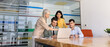 © fizkes - Diverse businesspeople discussing project on laptop, listening to woman colleague explaining data, pointing on screen, reviewing business presentation together during corporate office briefing, banner