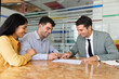 © fizkes - Multiethnic couple signing contract document during business meeting with bank advisor, company manager in office. Legal agreement confirmation, financial or real-estate deal, client services concept
