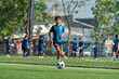 © chokniti - World cup concept with soccer ball or football player, soccer player on field near goal net during outdoor team practice, active youth training on grass