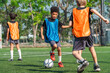 © chokniti - World cup concept with soccer ball or football player, young child playing soccer on field with ball and colorful vest