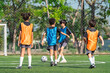 © chokniti - World cup concept with soccer or football player, children soccer practice on outdoor field, youth sport teamwork and training