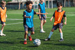 © chokniti - World cup concept with soccer or football player, youth soccer practice children soccer field team sports training ball school outdoor
