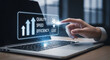 © fitria - A hand interacts with a digital interface on a laptop screen, displaying business growth metrics like quality, speed, efficiency, and cost.