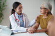 © Tj - Asian female doctor providing compassionate care and support to a senior patient during a routine medical examination, offering comfort and building trust