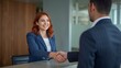 © Haadi - Woman shaking hand with businessman at office reception desk