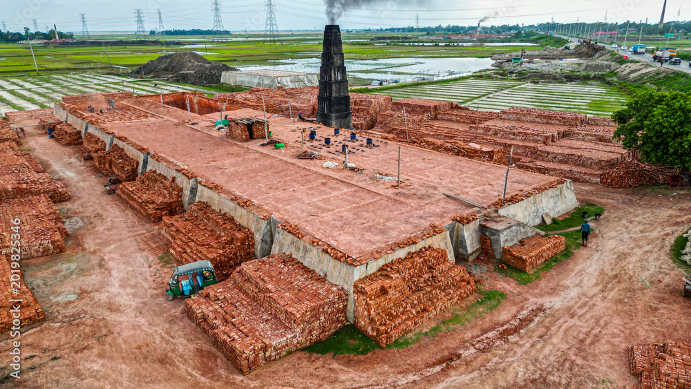 Brick manufacturing process at a factory with stacks of bricks ready ...