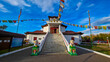 © robertharding - Buddhist Tsechenling Temple located in Kyzyl, Republic of Tuva, Russia with colorful flags and lion statues at entrance