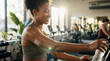 © D-point - Young african american woman with a glucose monitoring device on her arm workout in gym. Continuous glucose monitoring for diabetes management.