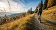 © twilight mist - Woman Mountain Biking on a Scenic Trail in the Mountains During a Sunn