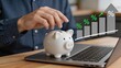 © Lisa - Person putting coin in piggy bank with rising percentage bar graph, financial savings investment growth and money management concept