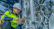 © reewungjunerr - Asian electric engineer holding clipboard for checking and monitoring the electrical system in the control room,Technician thailand people working