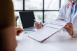 © David - Doctor discussing health assessment form with patient during medical consultation, explaining treatment plan and gathering health information in clinic or hospital office
