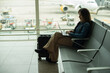 © Gusta Cabrera - Businesswoman working on her computer with the runway in the background.