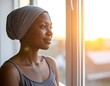 © supriyady - African American woman looking out window.