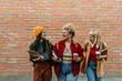 © La Famiglia - Diverse young women students laughing walking together
