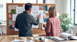 © Pamela - Creative interior designers reviewing mood board with fabric swatches and architectural sketches in studio.