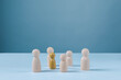 © Chaithawat - Diversity and inclusion concept with unique individual standing among a group of wooden figures. Symbolizing individuality, teamwork, leadership, community, equality and human resources.