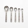 © sumbalmujeeb - Lab measuring spoons isolated on white background small tools