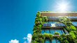 © Vladimir Zlotnik - Modern eco friendly residential building with solar panels and green facade under a blue sunny sky with copy space
