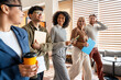 © Maria Vitkovska - Diverse business team collaborating smiling walking through office