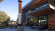 © Bon - Modern home exterior with outdoor heater, patio furniture, and backyard