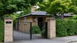 © Nataliia_Trushchenko - Residential brick house with black gate and lush greenery surrounding the entrance, featuring a well-maintained front yard and a clear sky in the background