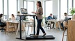 © Stitch - Businesswoman leading a video conference on her laptop while walking on an under desk treadmill