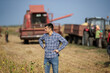 © Budimir Jevtic - Farmer standing in front of combine harvester