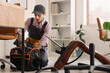 © Pixel-Shot - Male worker with bag of tools assembling chair in office