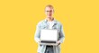 © Pixel-Shot - Young man with laptop on yellow background