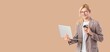 © Pixel-Shot - Young blond businessman with laptop and coffee on beige background with space for text