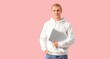 © Pixel-Shot - Young man with laptop on pink background