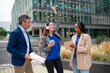 © Miquel - Business team celebrating success outdoors with music and tablet