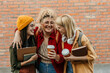 © La Famiglia - Three happy female students laughing enjoying coffee break