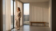 © TheLestari - Peaceful woman looking out window at sunset