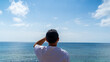 © Sona - Back view of a man sitting on the seawall and looking at the summer sea 2