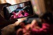 © Antonio Recena - Smartphone Capturing Tender Moment Between Little Girl and Baby at Home