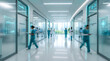 © FATIHAKHANDOKER - Medical professionals walking in a futuristic hospital corridor with glowing digital displays