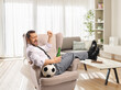 © Ljupco Smokovski - Man in formal clothing sitting in an armchair with a football and beer