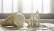 © Ai Stock Lab - Melting ice cream waffle cone miniature house architectural ruin white dessert soft light sunny window fantasy food surreal concept dripping cream Melting ice cream waffle cone with tiny