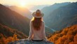 © Vadym - Woman with hat sits on rock looking over valley at sunset. Golden hour light illuminates mountains, trees. Enjoying nature, peaceful moment, travel adventure.