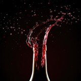Dramatic high-speed capture of rich red wine splashing vigorously out of an uncorked glass bottle, suggesting powerful pressure release and celebration ,spill ,splash ,maroon