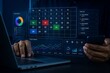 © njna - Person analyzes business data, charts, and graphs on a holographic dashboard while using a laptop and smartphone.
